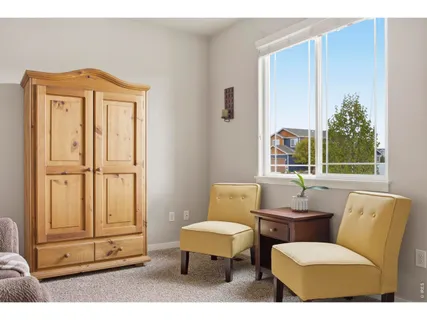 a living room with furniture a window and a potted plant
