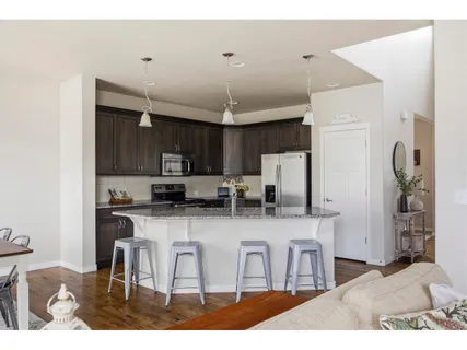 a kitchen with stainless steel appliances a microwave a stove and refrigerator