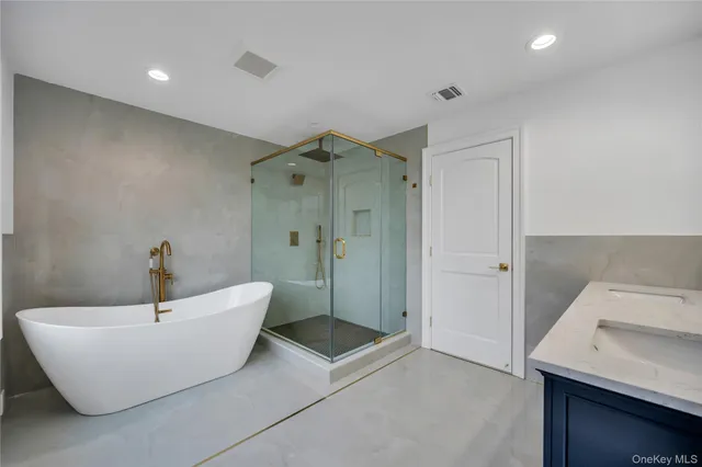 a bathroom with a bathtub and shower