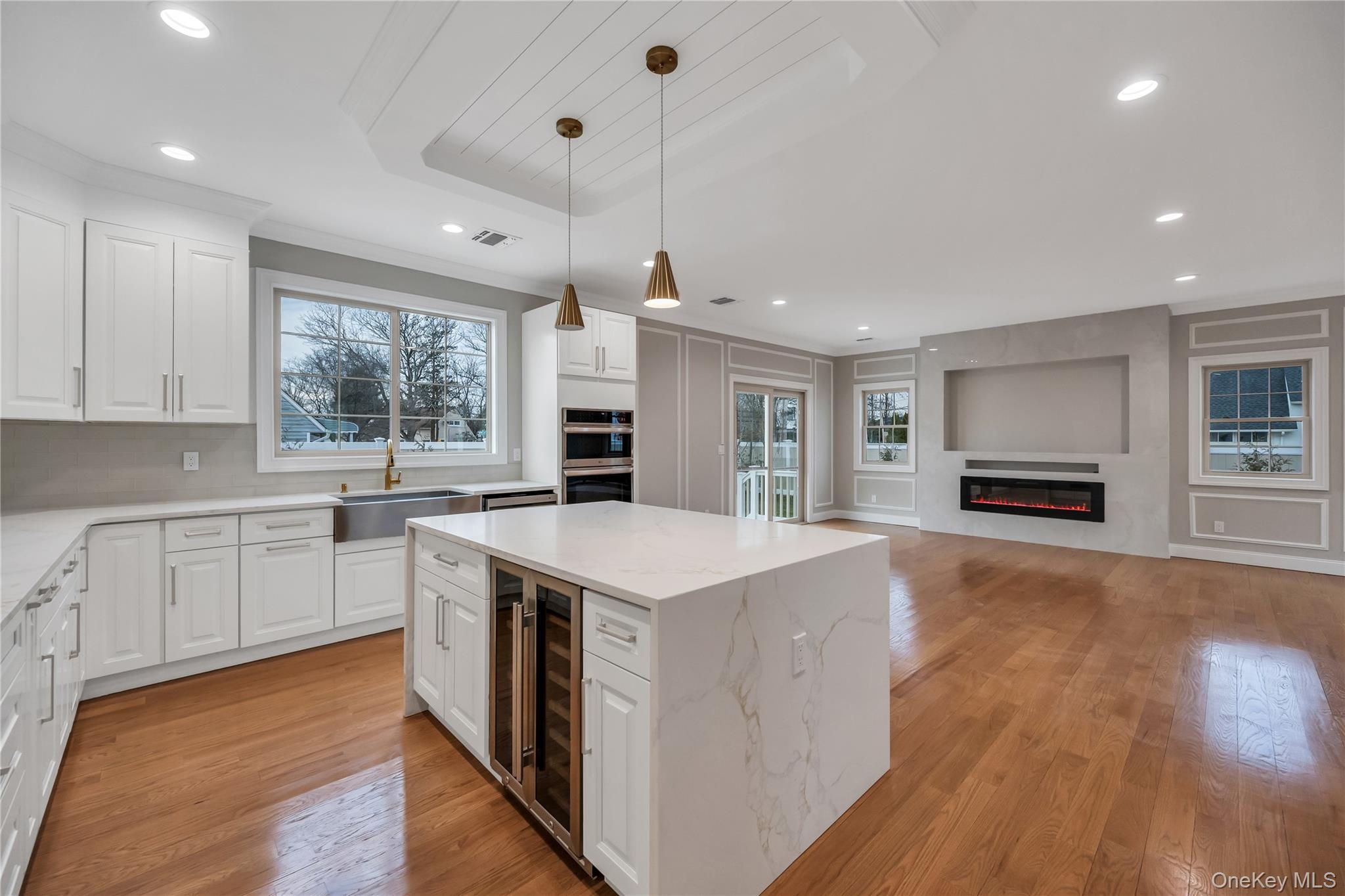 319 Blacksmith Road Levittown, NY 11756 - Photo 5 of 16 Kitchen with a sink, wine cooler, double oven, a center island, and crown molding