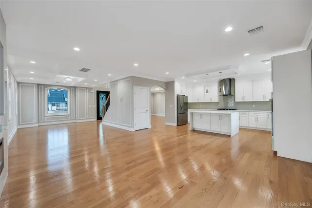 a view of kitchen with kitchen island and stainless steel appliances