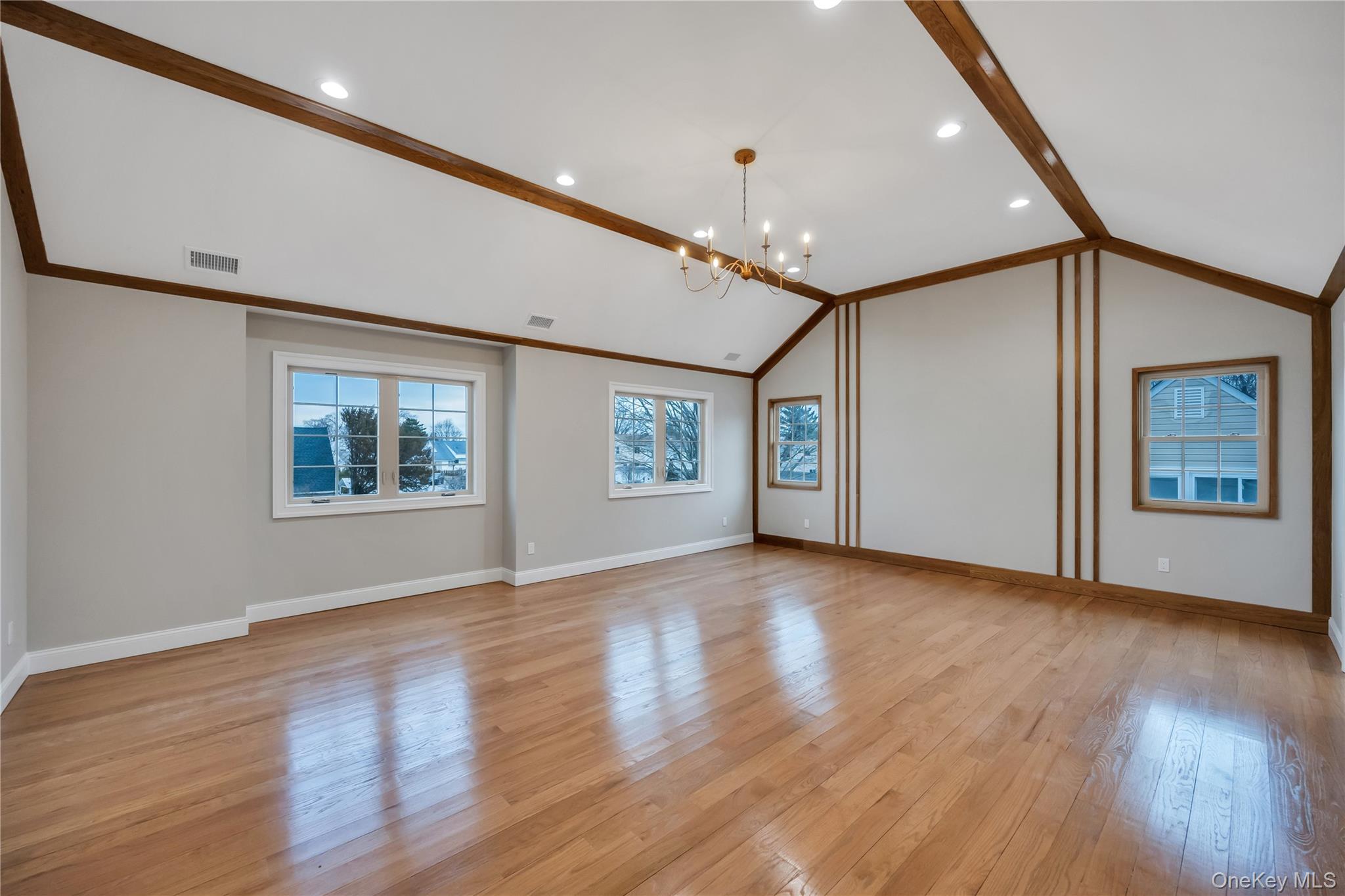 319 Blacksmith Road Levittown, NY 11756 - Photo 9 of 16 Unfurnished living room featuring a chandelier, light wood-style floors, baseboards, and recessed lighting