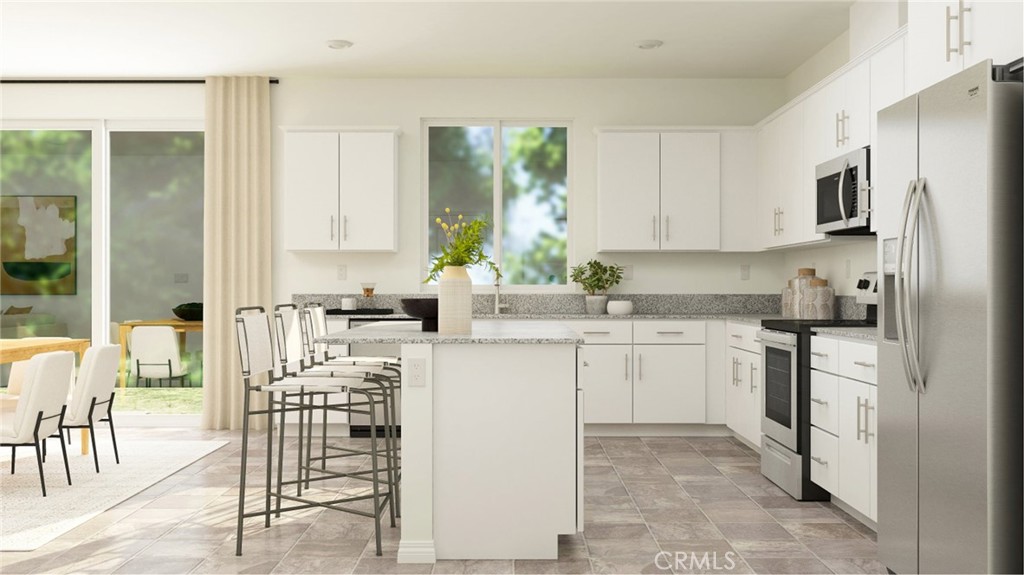 2386 Peach Tree Lane Perris, CA 92570 - Photo 3 of 23 a kitchen with appliances cabinets and a sink