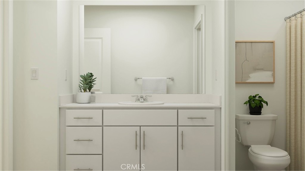 2386 Peach Tree Lane Perris, CA 92570 - Photo 8 of 23 a bathroom with a sink a toilet and a mirror