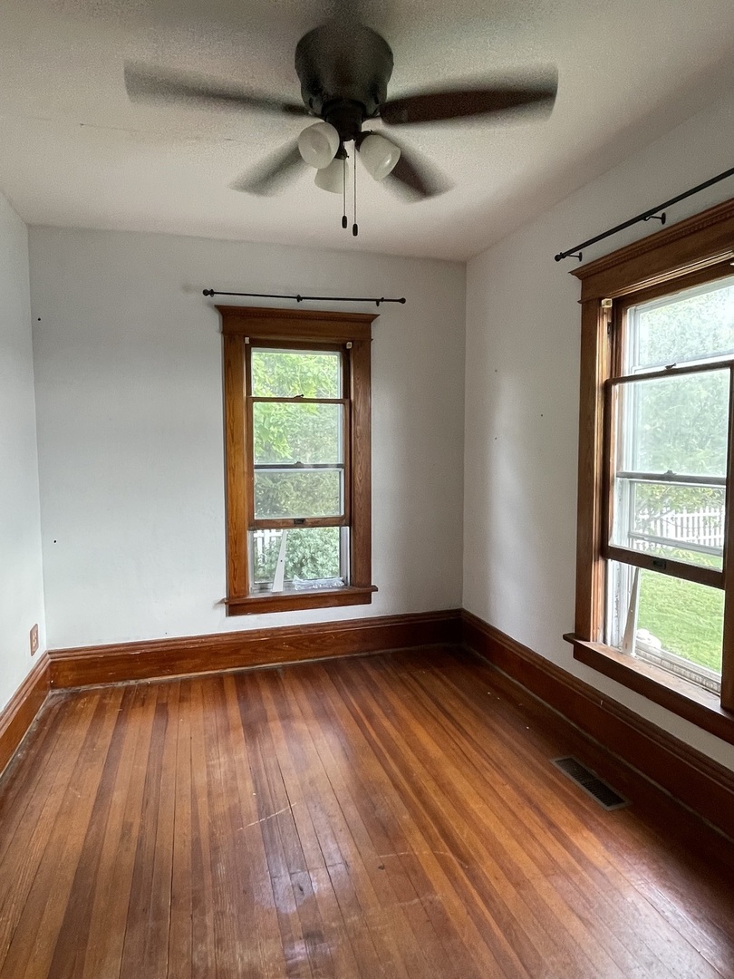 4591 Main Street Irwin, IL 60901 - Photo 20 of 29 wooden floor in an empty room with a window