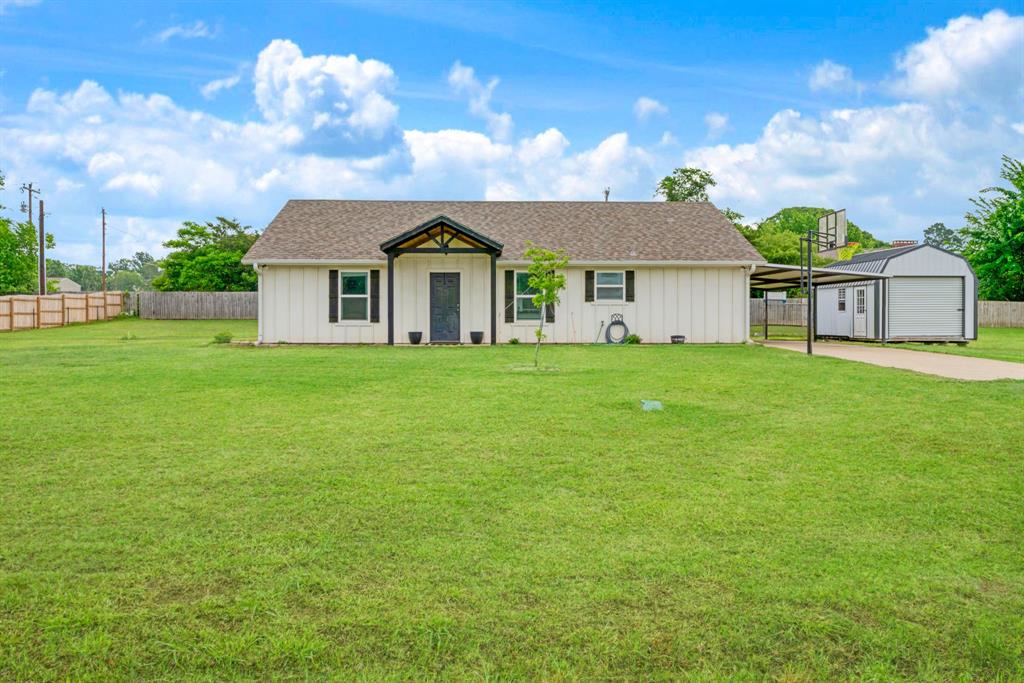 134 Private Road Paris, TX 75462 - Photo 1 of 19 a view of a house with a big yard and a large tree