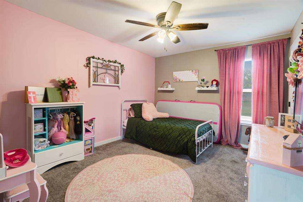 134 Private Road Paris, TX 75462 - Photo 11 of 19 a bedroom with a bed and a chandelier