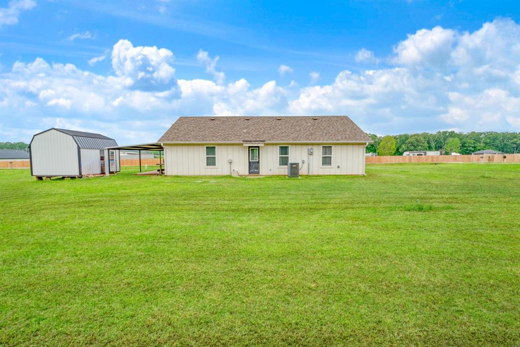 134 Private Road Paris, TX 75462 - Photo 16 of 19 a view of a house with a big yard and large trees
