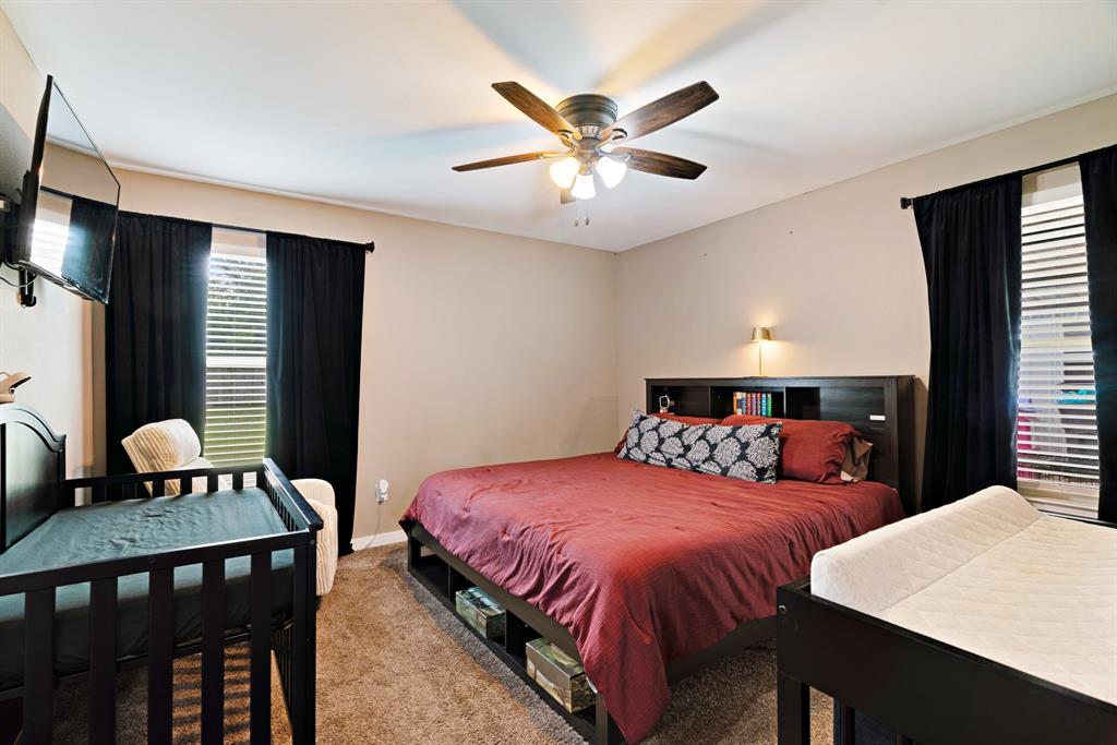 134 Private Road Paris, TX 75462 - Photo 9 of 19 a bedroom with a bed and a table in it