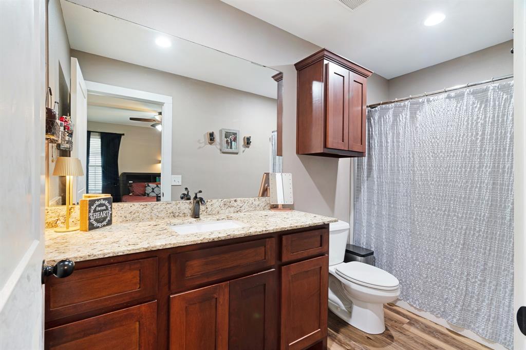 134 Private Road Paris, TX 75462 - Photo 10 of 19 a bathroom with a granite countertop sink toilet a mirror and shower
