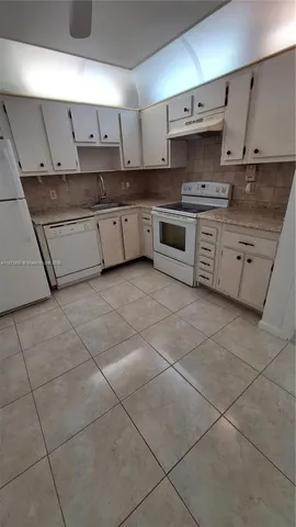 a kitchen with stainless steel appliances a sink and a stove