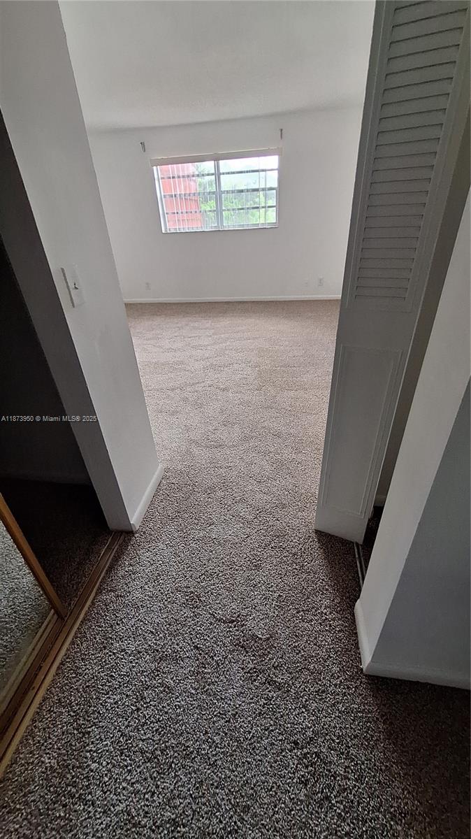 22605 Southwest 66th Avenue, Unit 409 Boca Raton, FL 33428 - Photo 13 of 19 a view of an empty room and window