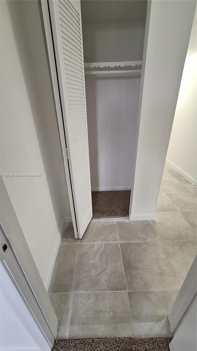 22605 Southwest 66th Avenue, Unit 409 Boca Raton, FL 33428 - Photo 15 of 19 a view of an empty walk in closet