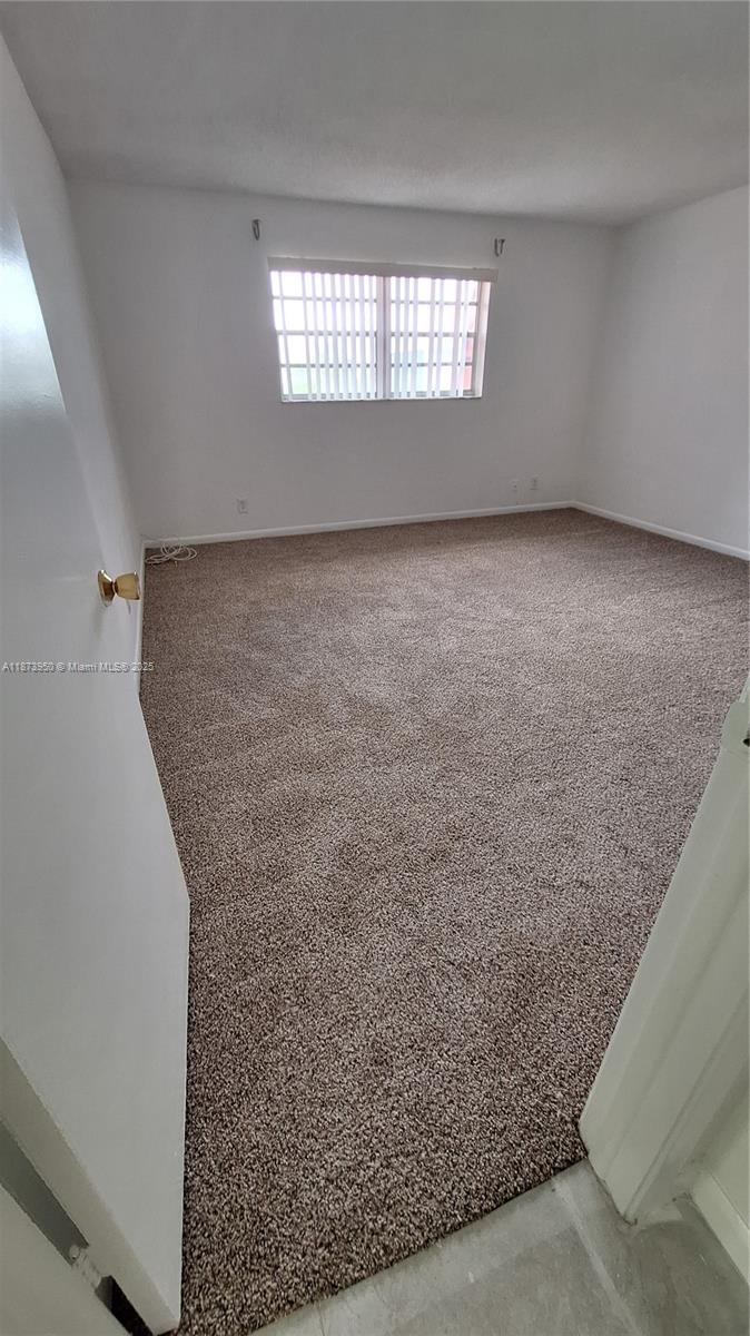 22605 Southwest 66th Avenue, Unit 409 Boca Raton, FL 33428 - Photo 16 of 19 an empty room with windows