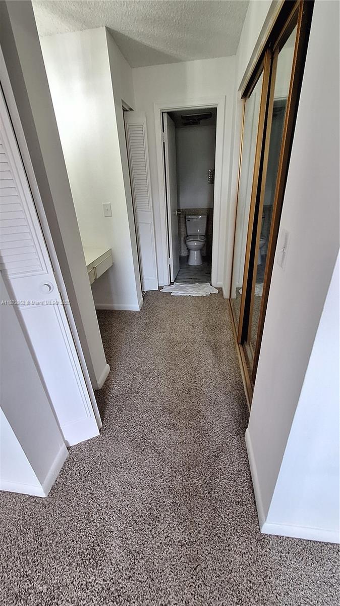 22605 Southwest 66th Avenue, Unit 409 Boca Raton, FL 33428 - Photo 17 of 19 a view of a hallway and stairs