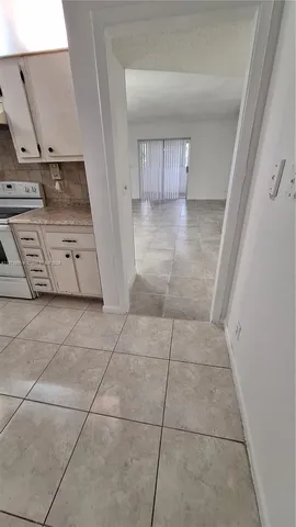 a view of kitchen with microwave and refrigerator