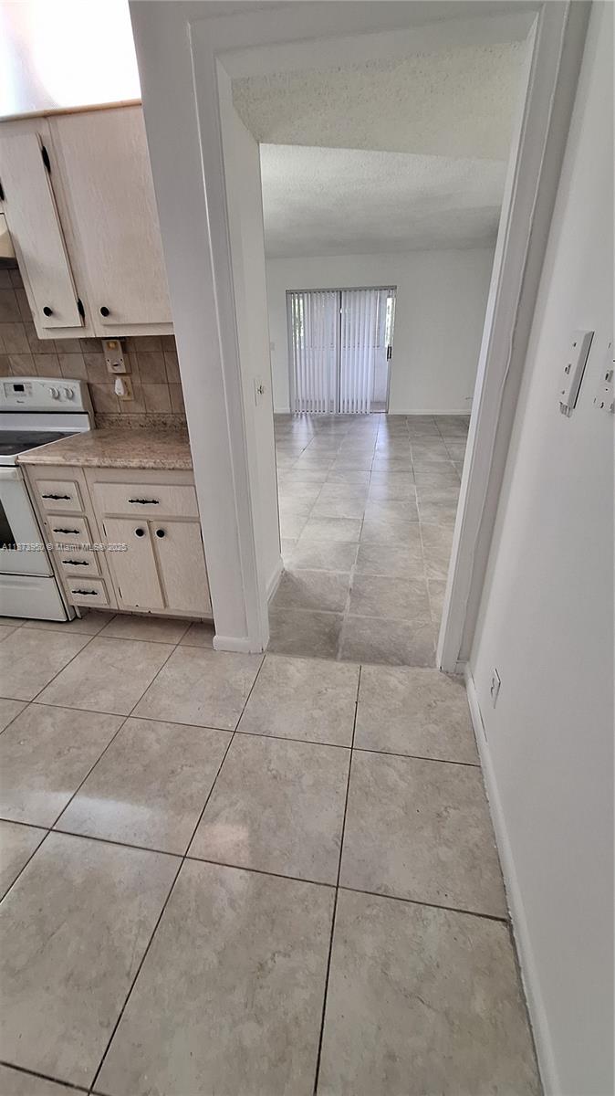 22605 Southwest 66th Avenue, Unit 409 Boca Raton, FL 33428 - Photo 6 of 19 a view of kitchen with microwave and refrigerator