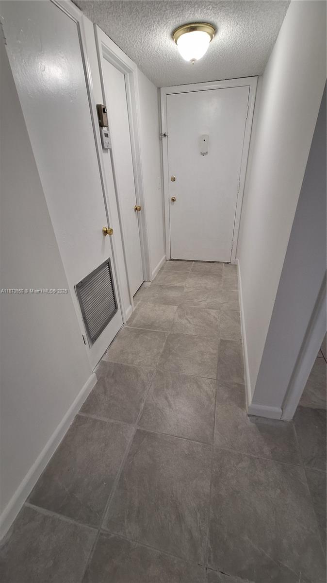 22605 Southwest 66th Avenue, Unit 409 Boca Raton, FL 33428 - Photo 7 of 19 a view of a big room with staircase and white walls