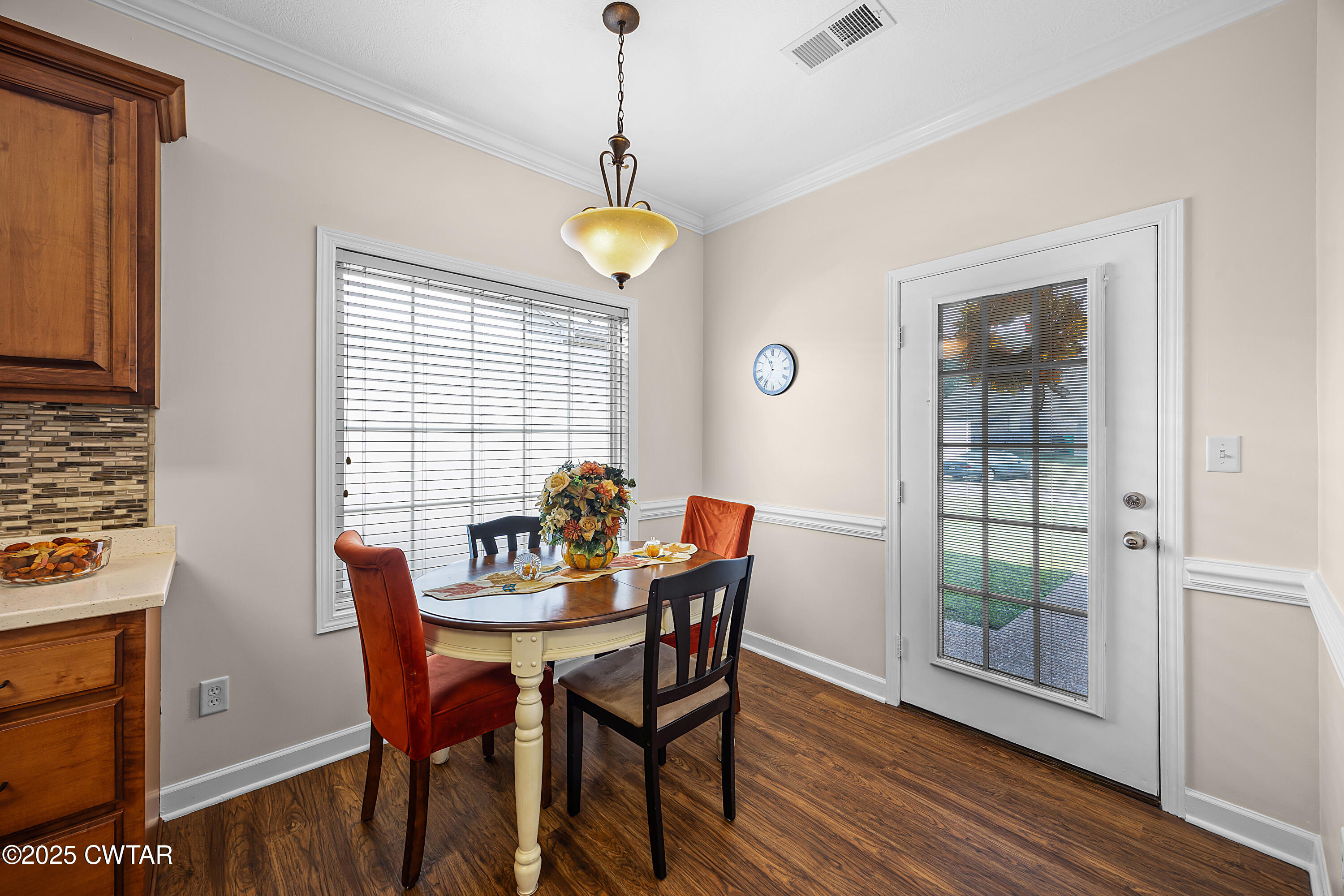 a view of a dining room with furniture window and wooden floor