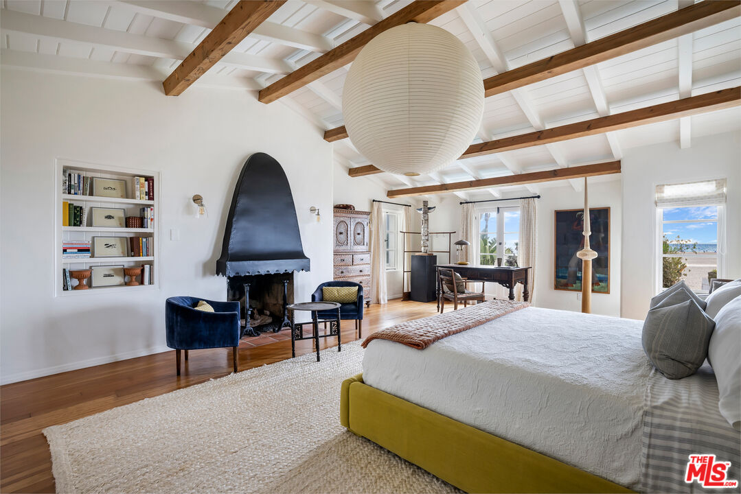 1020 Palisades Beach Road Santa Monica, CA 90403 - Photo 12 of 41 a large bedroom with furniture fireplace and window