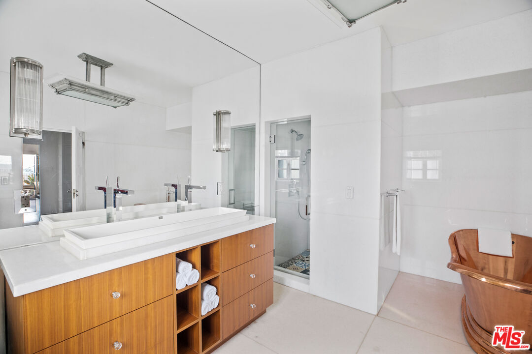 1020 Palisades Beach Road Santa Monica, CA 90403 - Photo 14 of 41 a bathroom with a granite countertop sink a toilet a mirror and shower