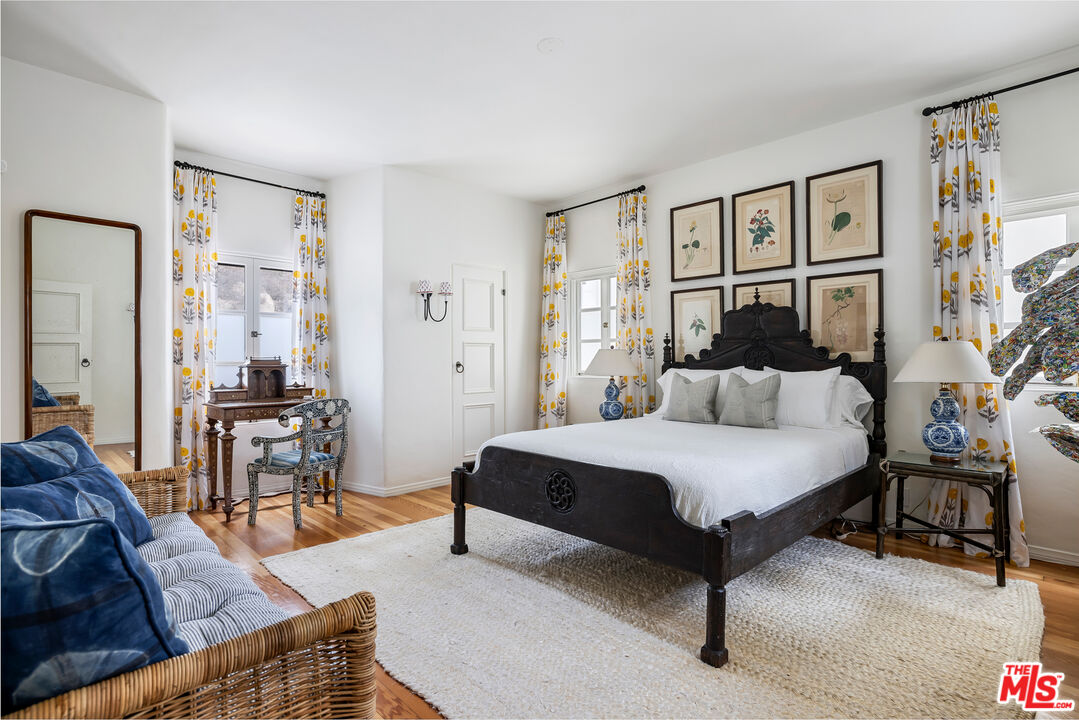1020 Palisades Beach Road Santa Monica, CA 90403 - Photo 18 of 41 a spacious bedroom with a bed a table and a bookshelf