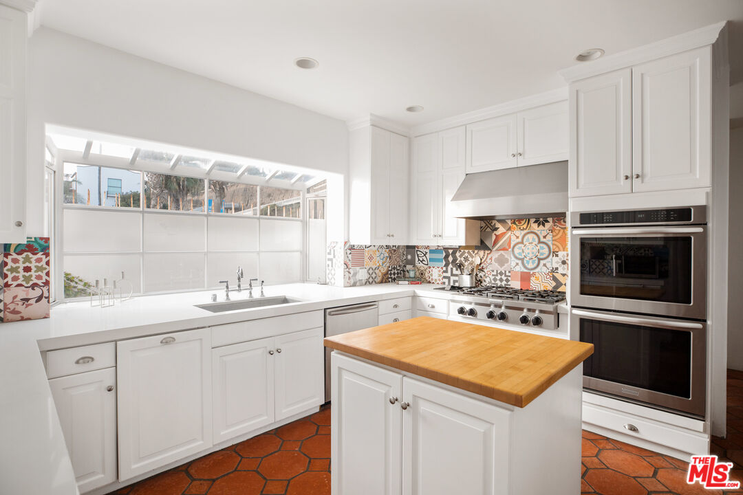 1020 Palisades Beach Road Santa Monica, CA 90403 - Photo 9 of 41 a kitchen with a sink stove and cabinets