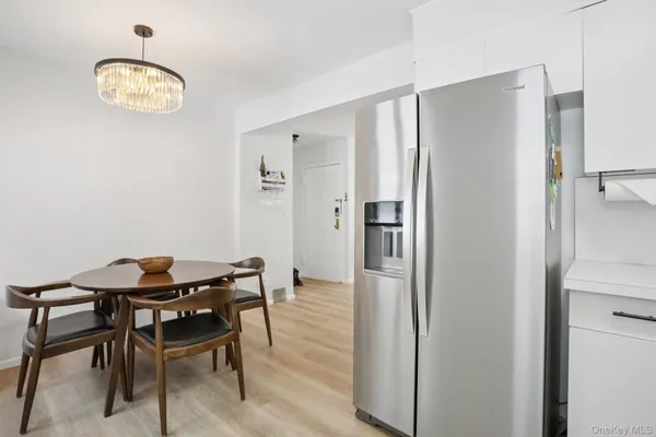 a view of a room that has a table and chairs in it