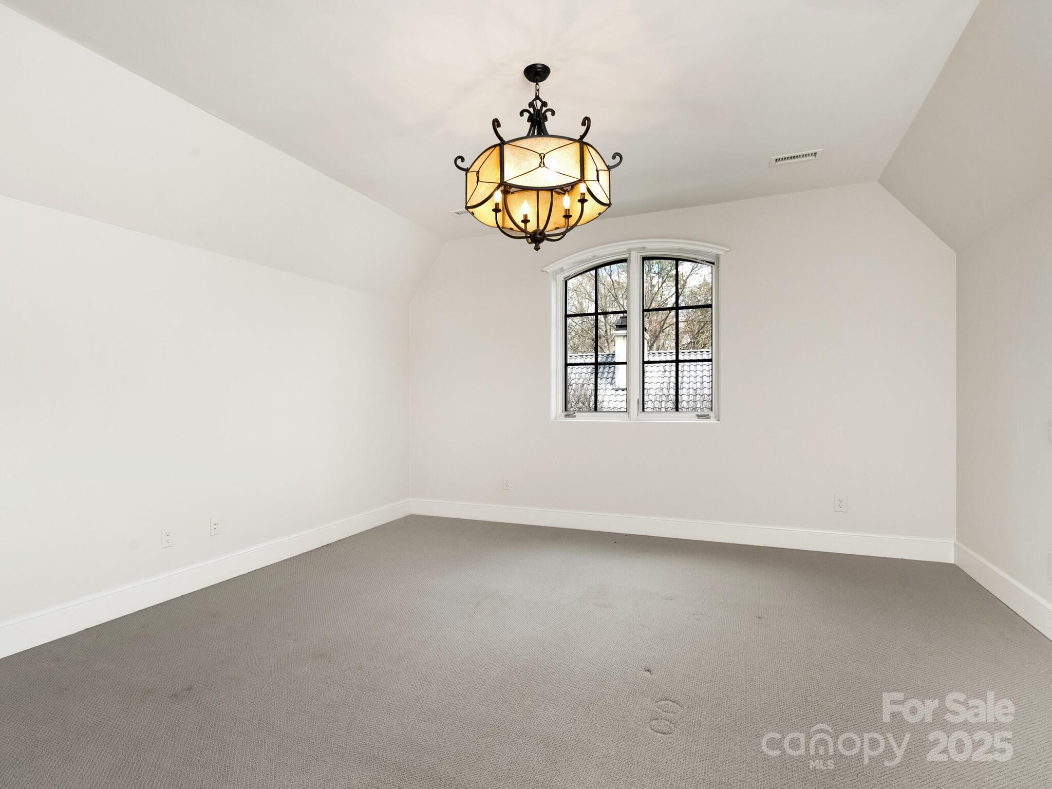 8525 Double Eagle Gate Way, Unit 2 Charlotte, NC 28210 - Photo 34 of 48 an empty room with windows and ceiling fan