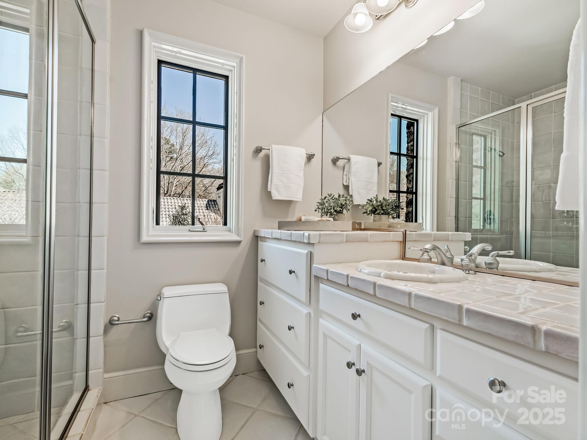 8525 Double Eagle Gate Way, Unit 2 Charlotte, NC 28210 - Photo 40 of 48 a bathroom with a toilet sink and mirror