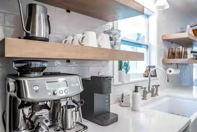 a kitchen with a sink a counter and a refrigerator