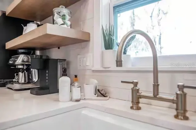 a kitchen with stainless steel appliances granite countertop white cabinets and a stove