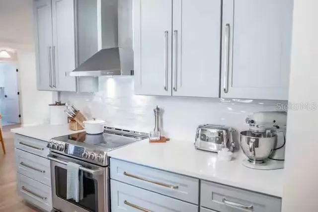 a kitchen with stainless steel appliances granite countertop a stove a sink and a refrigerator