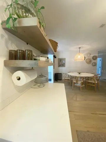 a bedroom with a bed and painting on the wall