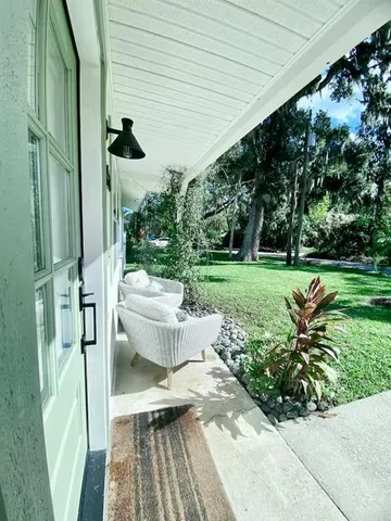 a view of a patio with table and chairs and potted plants