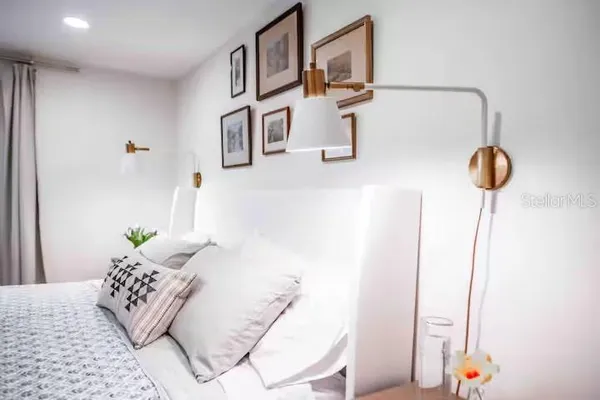 a bedroom with a bed and a lamp
