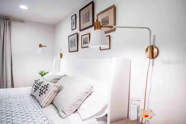 a bedroom with a bed and a lamp