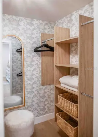 a view of walk in closet with clothes