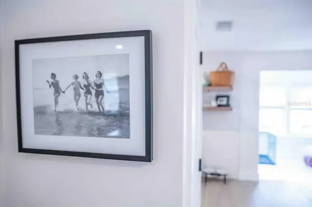 a view of a hallway with a painting on the wall