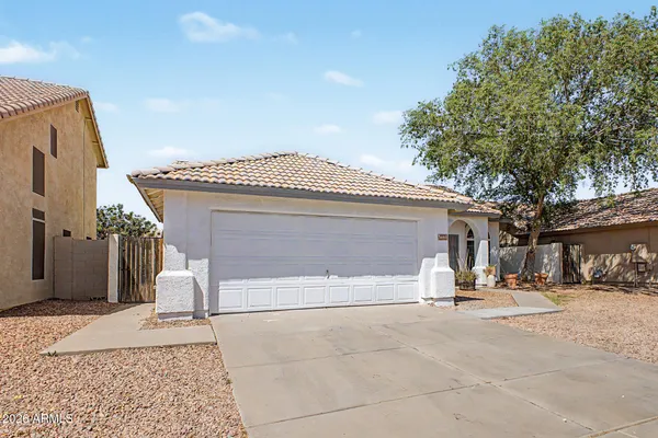 a view of a house with a yard and garage