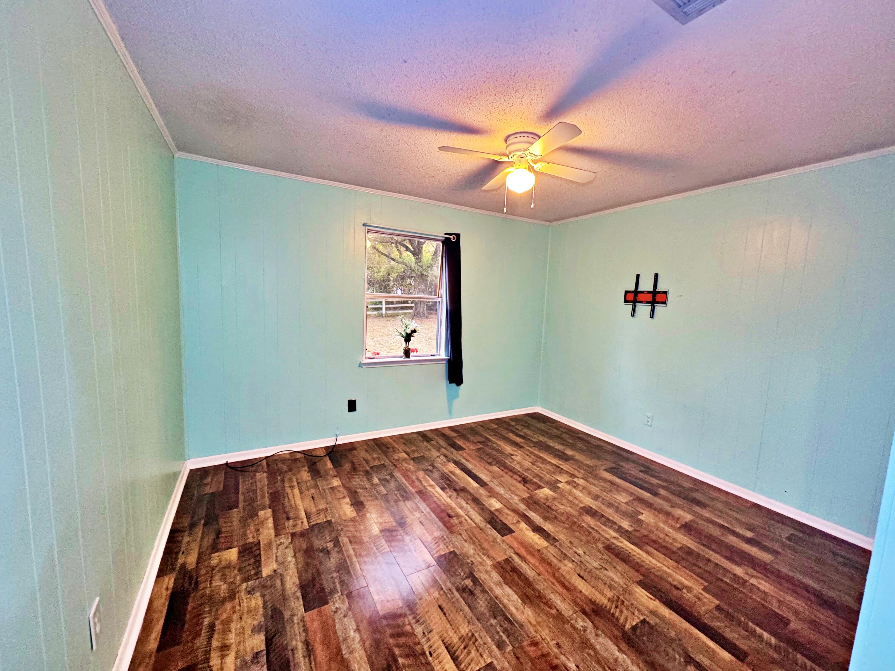 3183 Audrey Drive Crestview, FL 32539 - Photo 10 of 14 a view of a big room with wooden floor and windows