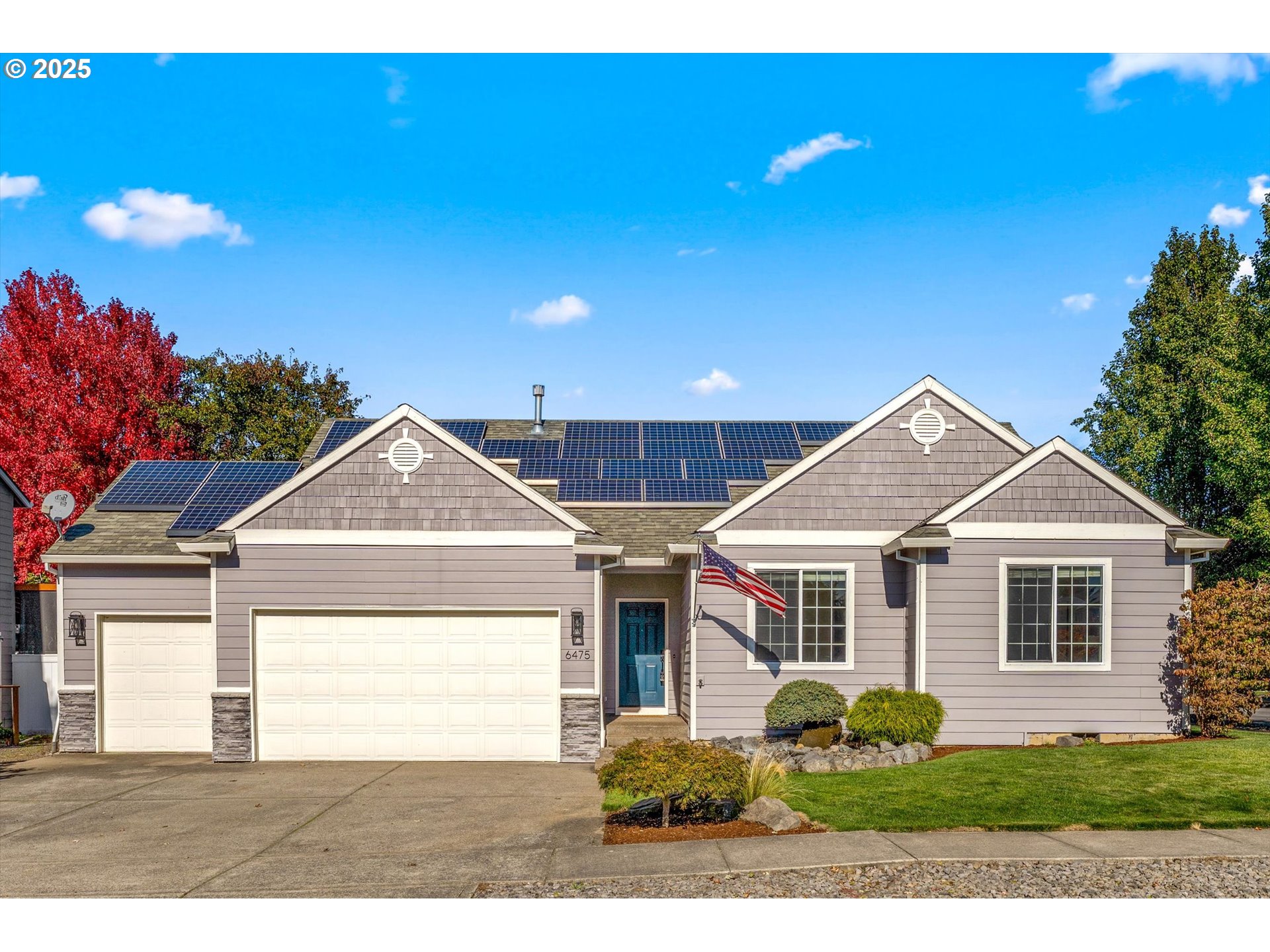 a front view of a house with a garden