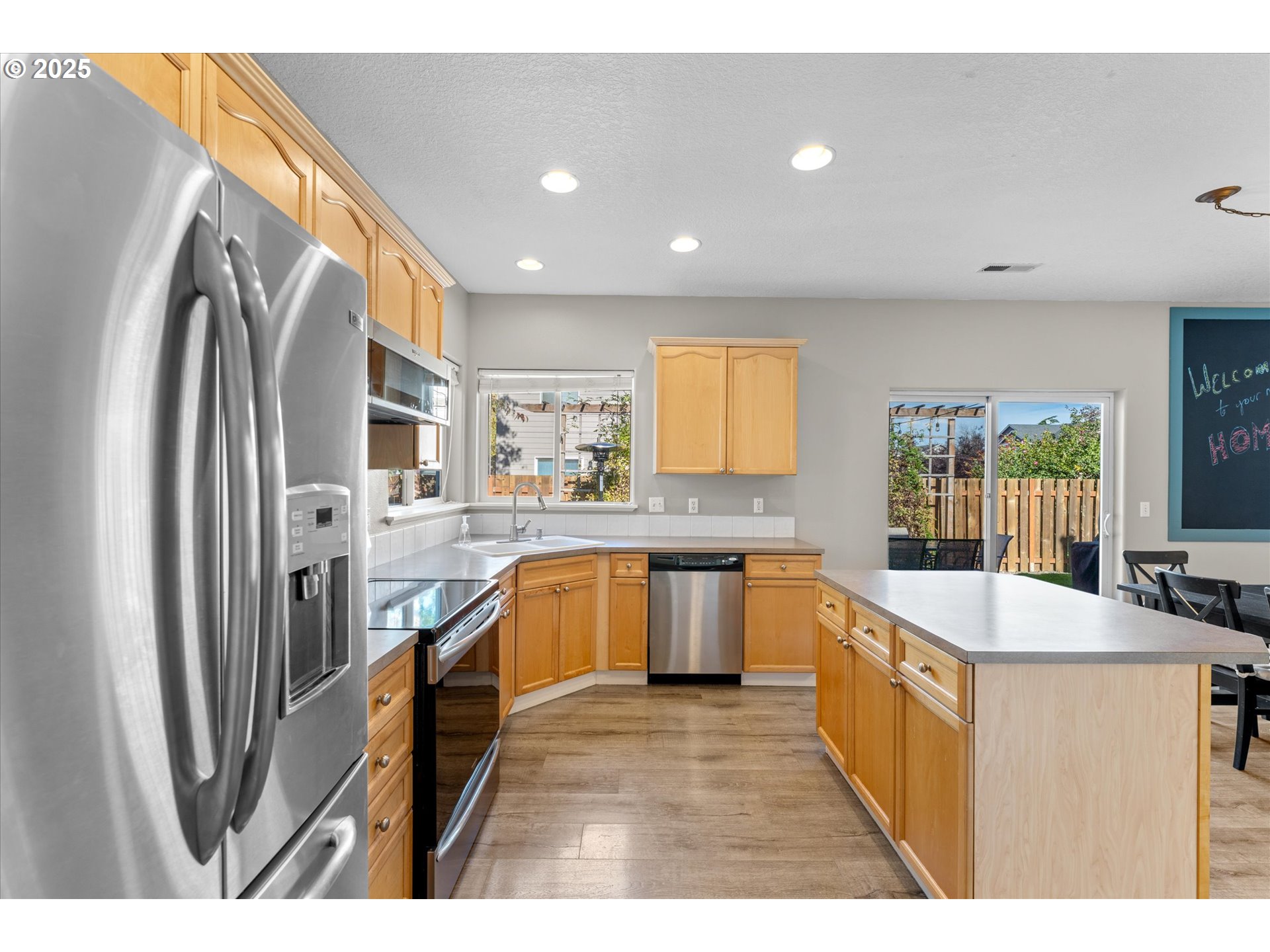 6475 Southeast 33rd Way Gresham, OR 97080 - Photo 11 of 47 an open kitchen with granite countertop a sink stove refrigerator and cabinets
