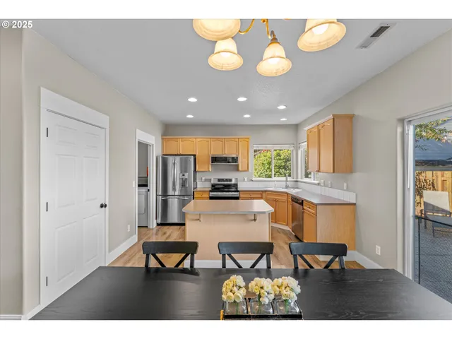 a view of a dining room with furniture and a chandelier