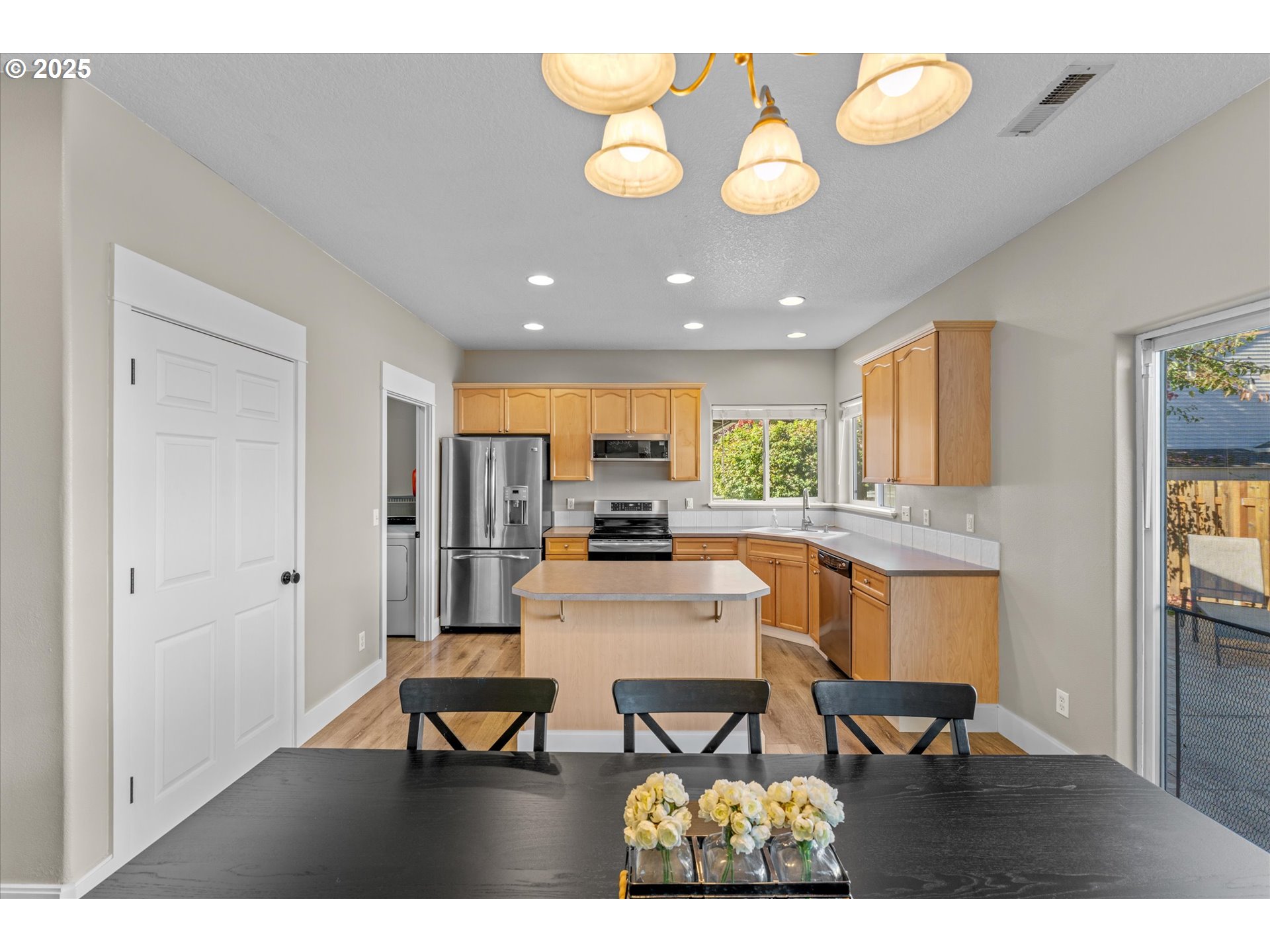 6475 Southeast 33rd Way Gresham, OR 97080 - Photo 12 of 47 a view of a dining room with furniture and a chandelier