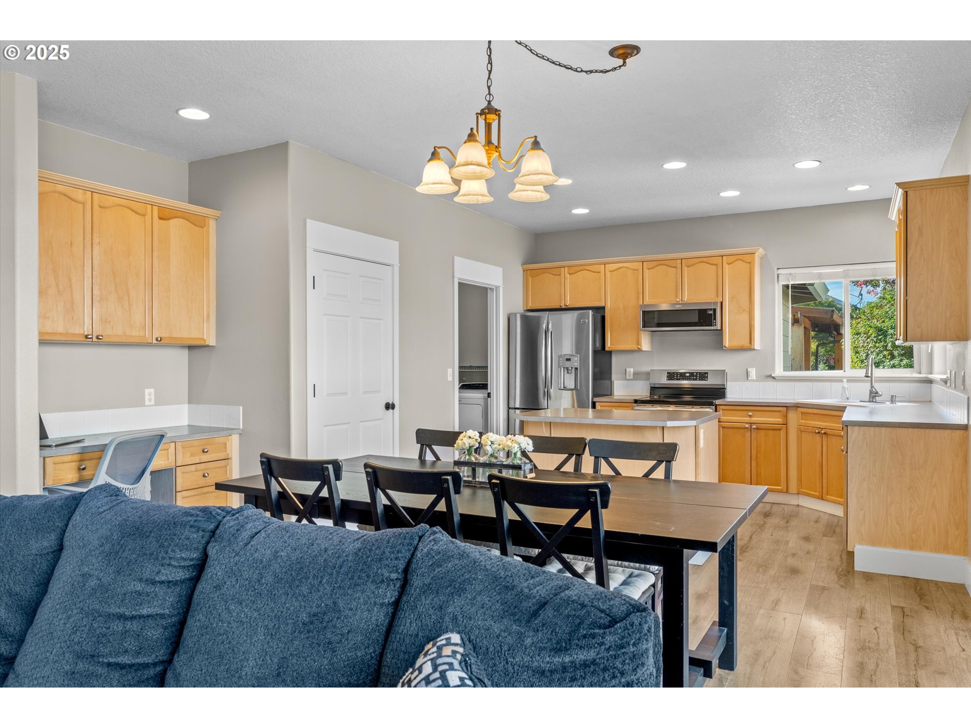 6475 Southeast 33rd Way Gresham, OR 97080 - Photo 23 of 47 a living room with couches a dining table chairs and kitchen view