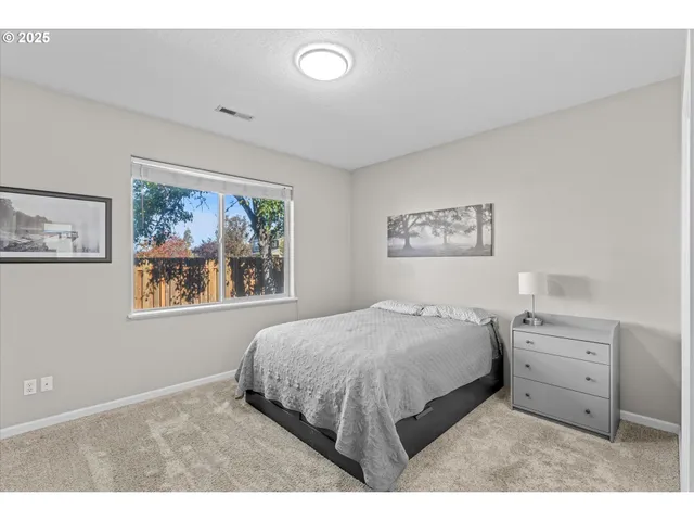 a bedroom with a bed and a lamp