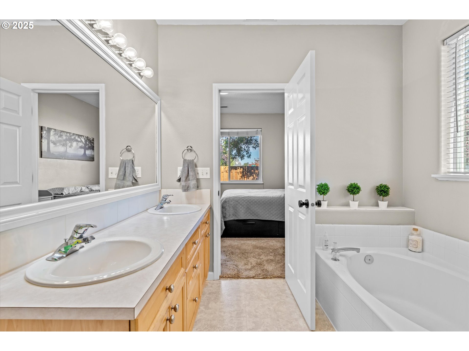 6475 Southeast 33rd Way Gresham, OR 97080 - Photo 33 of 47 a en suite bathroom with a double vanity sink a bathtub and a window