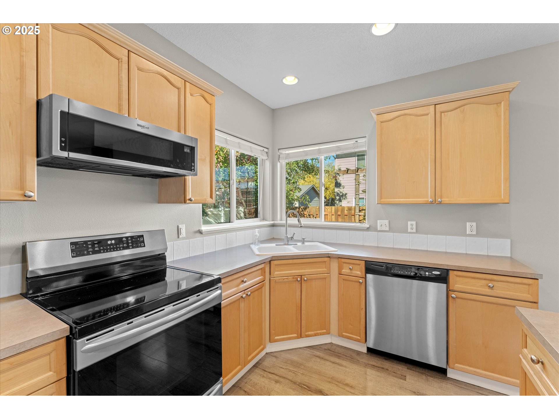 6475 Southeast 33rd Way Gresham, OR 97080 - Photo 10 of 47 a kitchen with stainless steel appliances granite countertop a stove a sink and a microwave