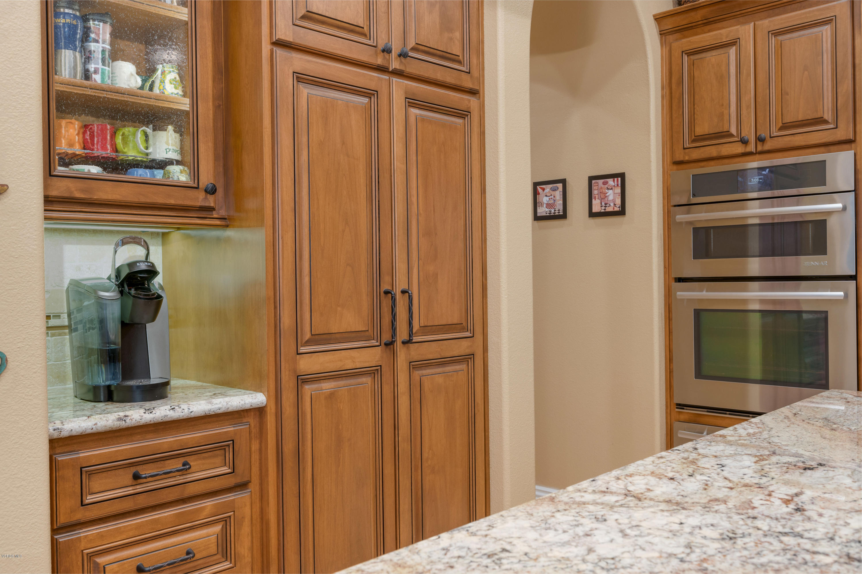 6945 Shadow Wood Drive Moorpark, CA 93021 - Photo 13 of 42 a kitchen with a refrigerator and cabinets